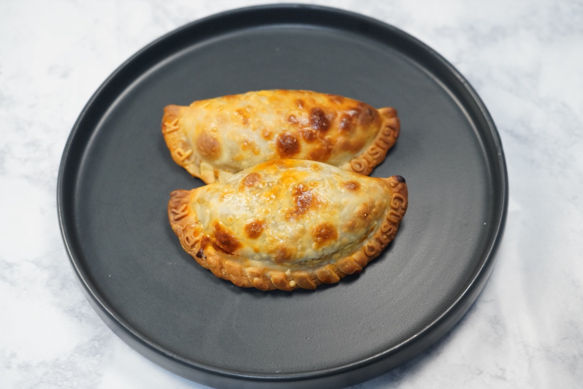 BBQ pulled pork empanadas with Gusto stamped in the crimped edge